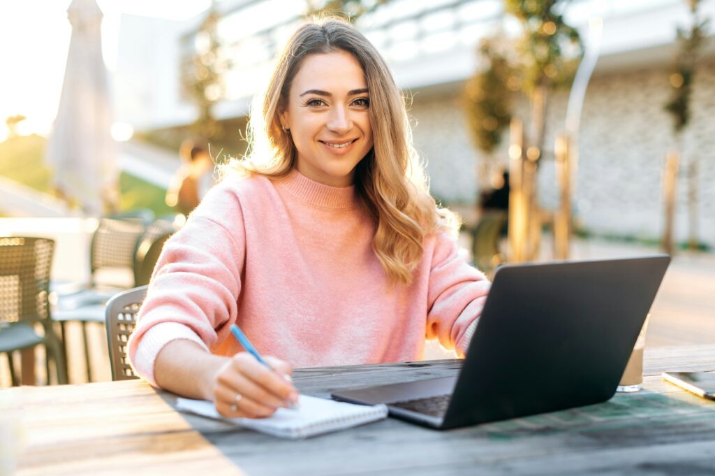 Beautiful confident young caucasian blonde woman, freelancer, student, creative manager, sits