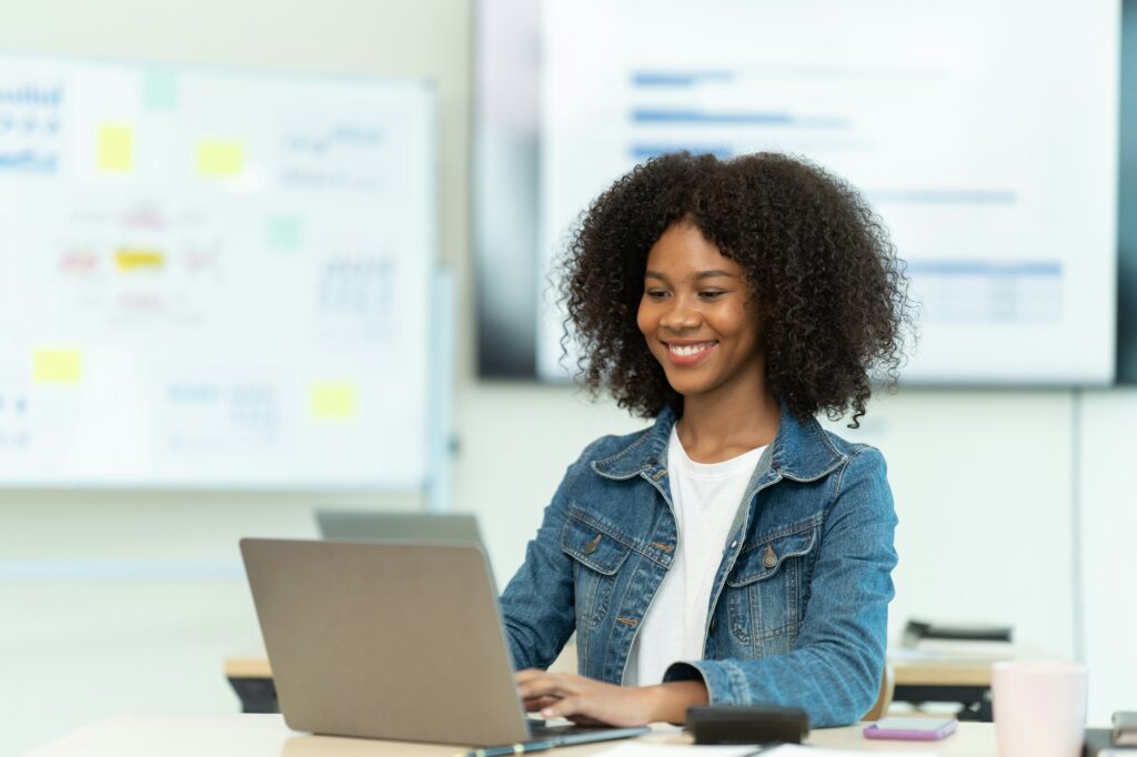 Smiling Successful African American Woman working with Big Data e-Commerce.